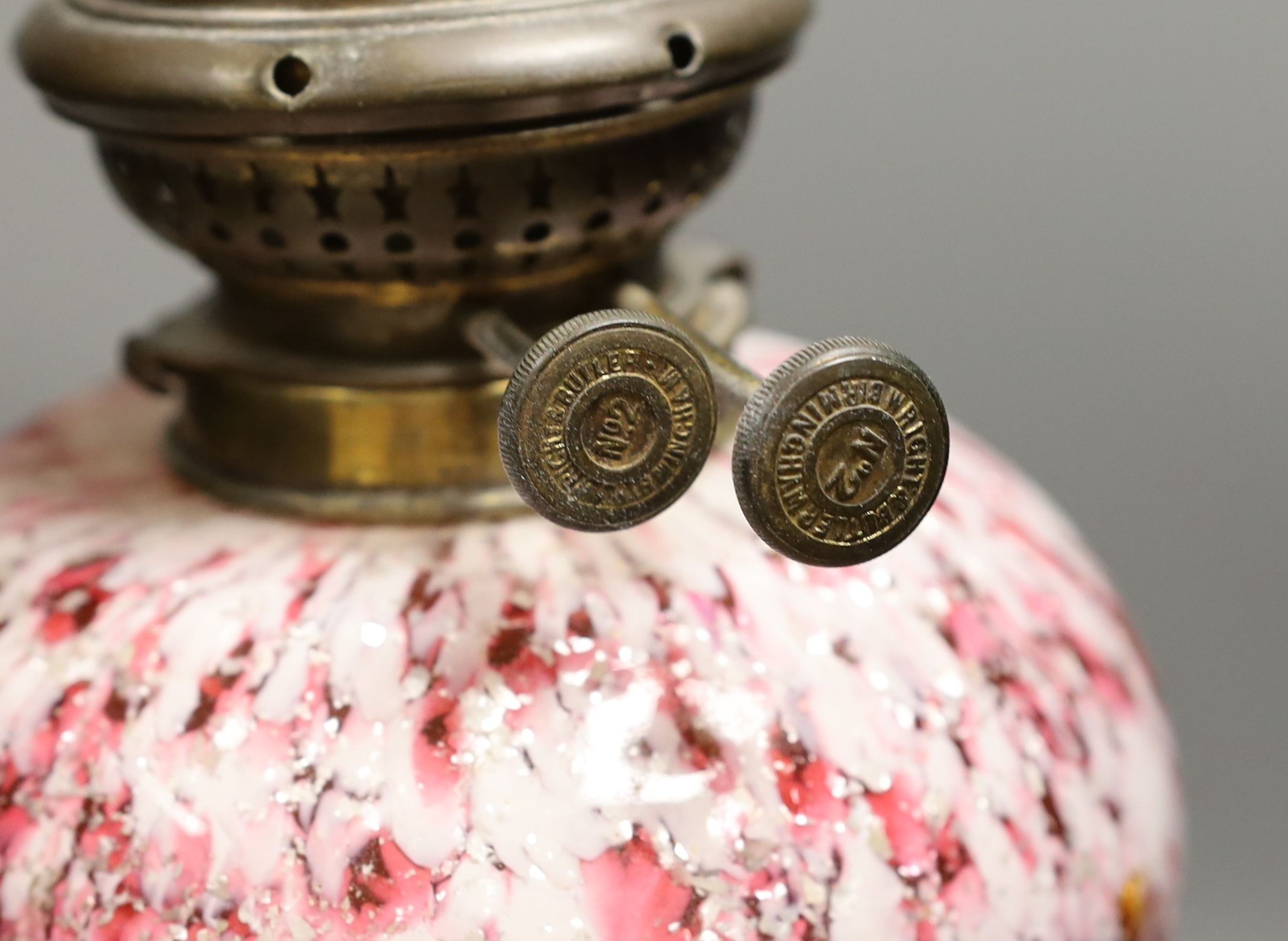 A 19th century mottled glass oil lamp, 55cm total height